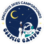 A circular logo with an astronaut holding a marshmallow on a stick under a crescent moon and stars. Text around the image reads “Spacious Skies Campgrounds Cosmic Camper.” Perfect for fans of the Spacious Skies Loyalty Program.